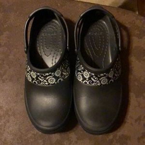 Black crocs with silver floral design